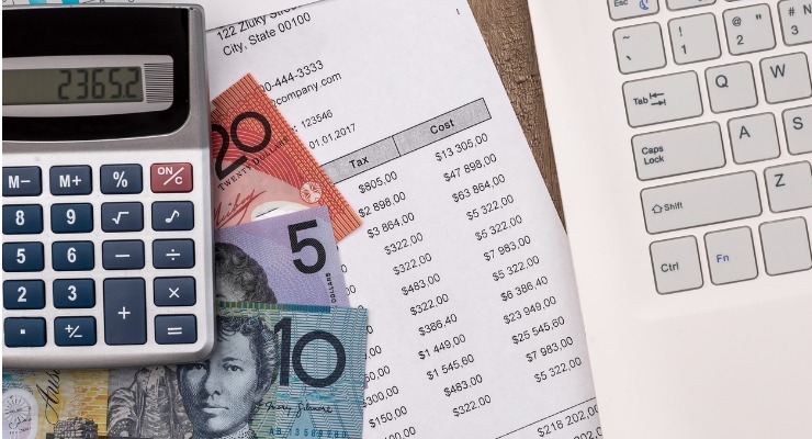 australian dollars and a calculator with taxes on a piece of paper 